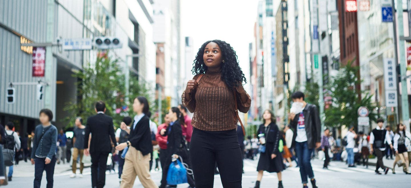 Young woman walking in a busy street